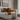 Image shows a candle burning in a contemporary living room to depict why candles may not smell strong enough